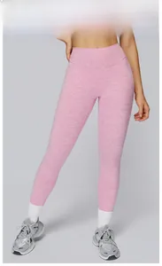 Detail view of high-waisted cherry blossom pink yoga pants with soft brushed texture