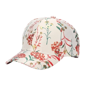 Close-up of vintage floral print on beige baseball cap with fine fabric texture details