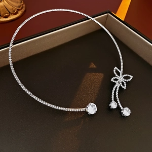 Detail shot of silver butterfly necklace with sparkling zircon tassels in a gift box