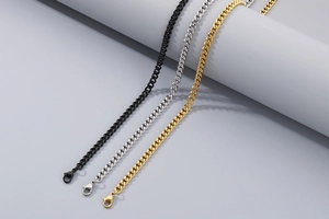 Three Cuban link chains in black, silver, and gold finish with lobster clasp closures