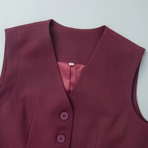 Close-up of a burgundy V-neck vest showing two resin buttons and size S inner label