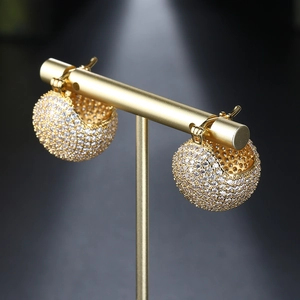 Luxurious gold ball hoop earrings with micro-pave cubic zirconia on a minimalist T-stand