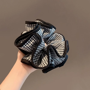 Classic black and white gingham scrunchie with ruffled layers and delicate black edging