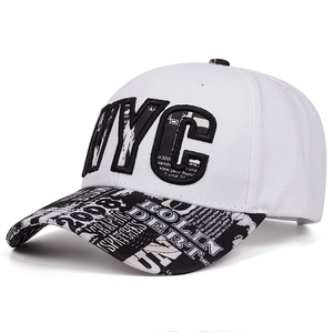 Detail of white NYC snapback cap showing embroidery and graffiti print flat brim