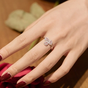 Close-up of S925 silver ring featuring pink heart-shaped gems in a floral setting