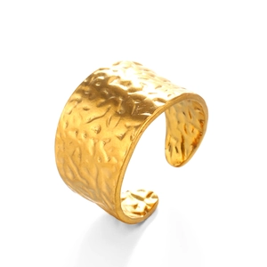 Polished wide gold hammered open ring in stainless steel for women on white background