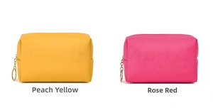 Detail view of loquat yellow and rose red PU leather waterproof makeup bags with gold zippers