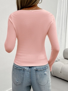 Back view of pink Y2K slim fit knit long sleeve top paired with blue jeans on a model