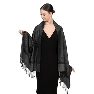 Detail of luxury black paisley jacquard shawl with elegant fringe and soft texture