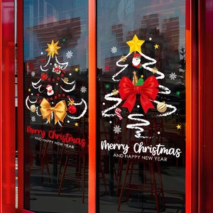 Christmas tree window decals with red bows and Merry Christmas lettering on glass