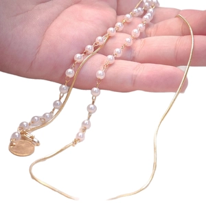 Double-layered gold pearl necklace with snake chain and circular pendant for women