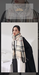 Close-up of beige plaid scarf featuring fringe tassels and soft cashmere-like texture