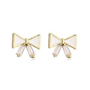 Golden bow earrings with white enamel and sparkling rectangular zircon tassels on white background