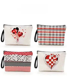 Detail of four canvas toiletry bags featuring various heart patterns and black wrist straps