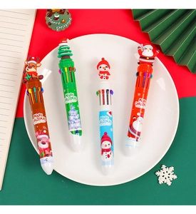 Close-up of Christmas 10-color shuttle pens with cute cartoon toppers on a festive tray