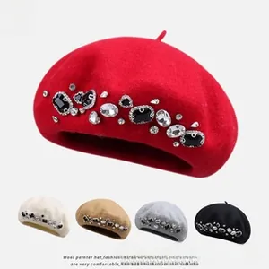 Detail of wool beret featuring luxury hand-sewn rhinestones and sparkling gemstones