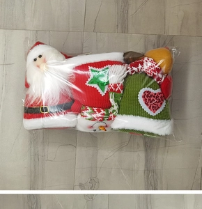Close-up of knit Christmas Santa and snowman ornaments with sequins in a clear package