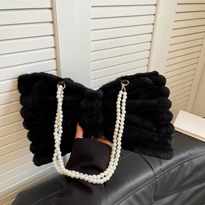 Plush black bow handbag featuring elegant double-row pearl handles and fluffy texture