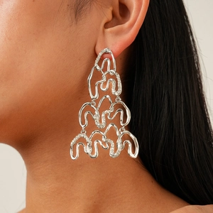 Irregular geometric silver needle earrings with shimmering crystals in a wavy design