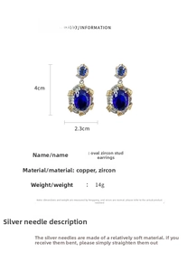 Detail view of blue oval zircon earrings showing 4cm x 2.3cm dimensions and 14g weight