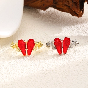 Gothic rose gold and silver rings with red coffin stones forming a heart shape