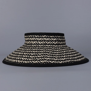 Detailed view of the wide brim and black and white geometric woven pattern of the sun visor
