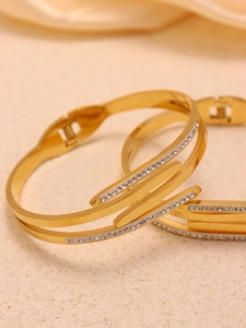 Macro view of gold-plated stainless steel hinge bracelet with micro-pave crystals