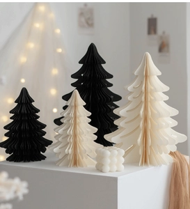 Detailed view of Nordic honeycomb paper Christmas trees in black and cream white with candlelight