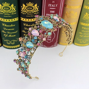 Macro detail of vintage gold crown with colorful crystals against antique books