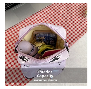 Detail showing inner storage of the Kuromi purple crossbody bag with various daily items