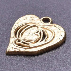 Macro shot of 18k gold heart pendant featuring a hammered texture and hollow design