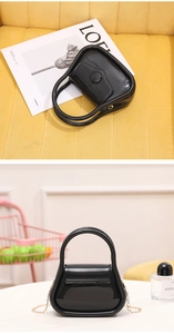 Chic black PVC jelly mini bag featuring a golden metal chain strap and top handle
