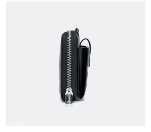 Side view of black genuine leather mini phone bag showing zipper and pebbled texture