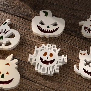 Macro shot of Halloween resin pumpkin and ghost pendants with Happy Halloween hollow text