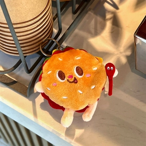Close-up of cute plush burger keychain with embroidery eyes and metal ring detail