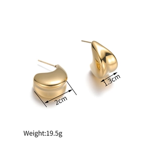 Macro detail of golden teardrop earrings showing 2cm width and 1.3cm thickness