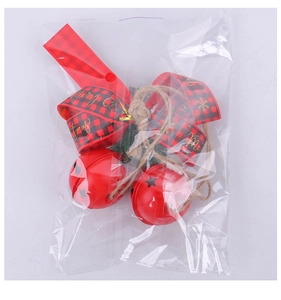 Detail of red Christmas bells with plaid bow and Merry Christmas text in clear packaging