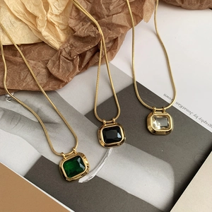 Luxurious gold snake chain necklace featuring square zircon pendants in green black and clear