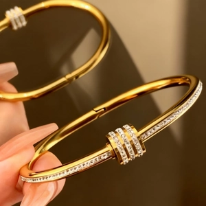Elegant gold stainless steel bangle with crystal accents and minimalist open cuff design