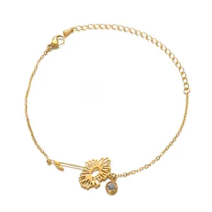 Detail of a gold sunflower charm bracelet with a clear sparkling birthstone and lobster clasp