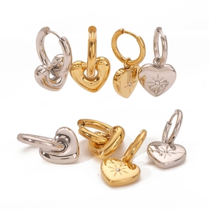 14k gold and silver heart hoop earrings with starburst pattern and cubic zirconia