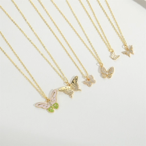 Detail of various butterfly pendants featuring colorful enamel and sparkling rhinestones