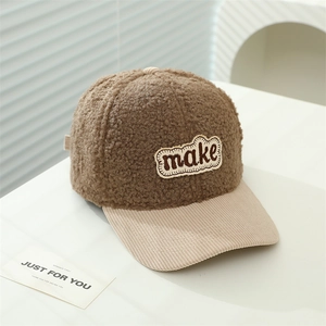 Detail of teddy fleece baseball cap with corduroy brim and make embroidered patch
