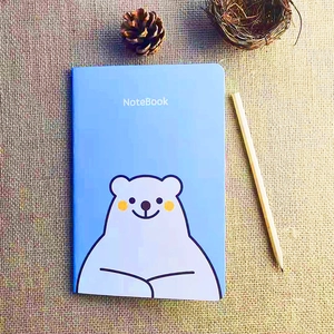 Lichtblauw notitieboek met cartoonbeer op jute achtergrond met natuurlijke decoratie