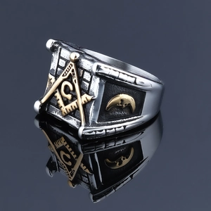 Macro shot of Freemasonry ring showing gold compass square and moon embossed details