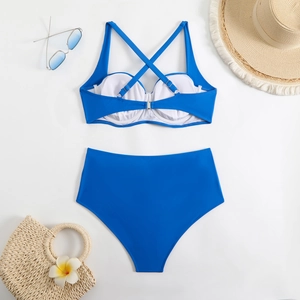 Flat lay of royal blue two-piece bikini with high-waisted bottoms and summer accessories