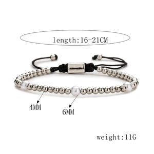 Close-up of zircon paved LOVE tube bracelet with pearls and adjustable black string