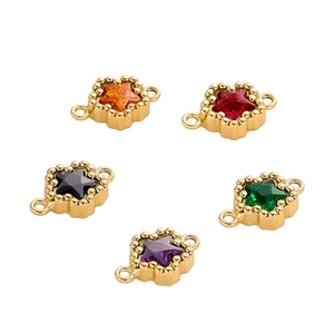 Detailed view of colorful star-shaped zircon charms with gold plating and double rings