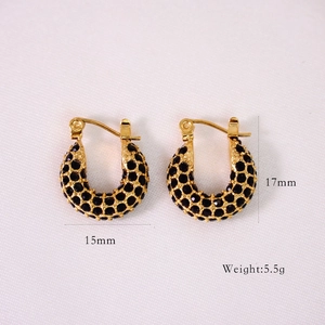 Macro view of gold hoop earrings with black zircon stones and 17mm x 15mm dimensions