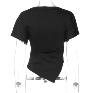 Detail of slim-fit black top featuring asymmetric hem and gathered ruched side detail